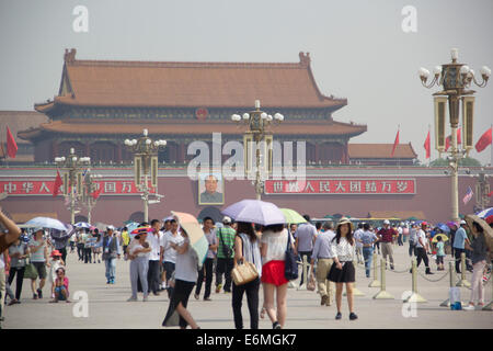 Tourists walk across Tiananmen Square, located in Beijing, China. Stock Photo