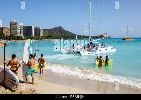 Honolulu Waikiki Beach Hawaii,Hawaiian,Oahu,Pacific Ocean,waterfront,sunbathers,surfboard,Kepoikai II catamaran,boat,Diamond Head Crater,extinct volca