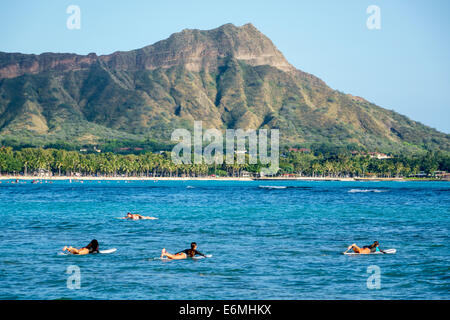 Honolulu Waikiki Beach Hawaii,Hawaiian,Oahu,Pacific Ocean,Waikiki Bay,Diamond Head Crater extinct volcano female women surfers Stock Photo