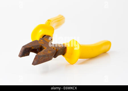 really old rusty pliers with yellow on white background Stock Photo