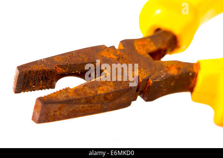 really old rusty pliers with yellow on white background Stock Photo