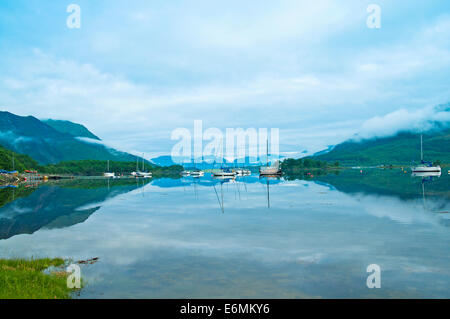 Yachts anchored in Loch Leven view towards Ardgour, early morning mist rising, seen from Glencoe, Lochaber, Highlands, Scotland Stock Photo