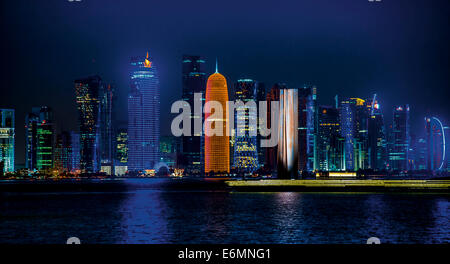 Night scene of the skyline of Doha with Al Bidda Tower, World Trade Center, Palm Tower 1 and 2, Burj Qatar Tower, Doha Corniche Stock Photo