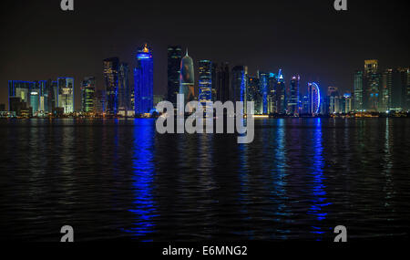 Night scene of the skyline of Doha with Al Bidda Tower, World Trade Center, Palm Tower 1 and 2, Burj Qatar Tower, Doha Corniche Stock Photo