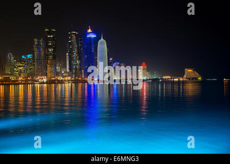 Night scene of the skyline of Doha with Al Bidda Tower, World Trade Center, Palm Tower 1 and 2, Burj Qatar Tower, Doha Corniche Stock Photo