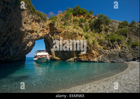 Excursion boat, natural arch, Arco Magno, San Nicola Arcella, Capo Scalea, Calabria, Italy Stock Photo