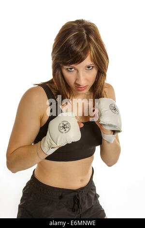 Young woman in sportswear wearing Wing Chun gloves, in a fighting stance Stock Photo