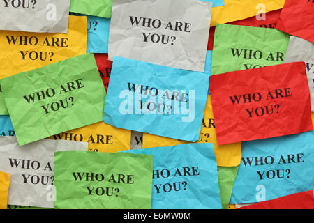 Crumpled colorful paper notes with the question "Who are you?". Stock Photo