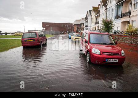 Localised flooding on Worthing seafront after very heavy summer rainfall overloads storm drains. Stock Photo