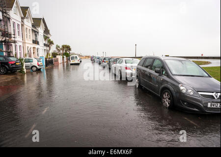 Localised flooding on Worthing seafront after very heavy summer rainfall overloads storm drains. Stock Photo