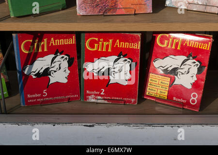 Three 3 copies of Girl Annual from the 1950s in a secondhand bookshop window. Stock Photo