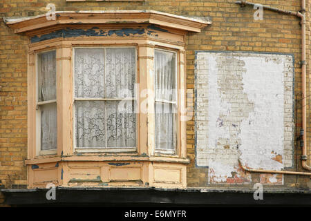 Old wooden sash bay window in need of restoration. Stock Photo