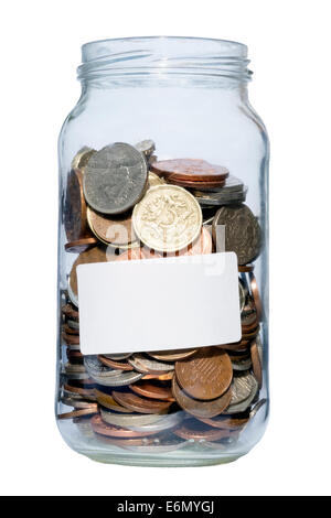 Jam jar full of coins, UK. Glass jar containing pounds & pennies savings. Stock Photo