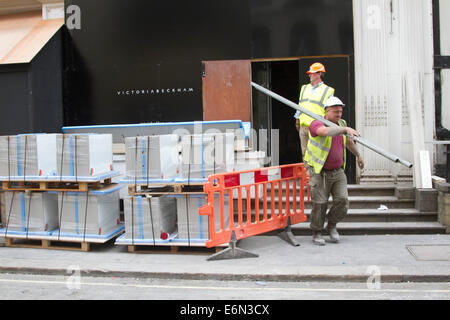 London,UK. 27th August 2014. Workers make preparations as former Spice Girl Victoria 'Posh Spice' Beckham is to open a shop in the fashionable district of Mayfair Credit:  amer ghazzal/Alamy Live News Stock Photo