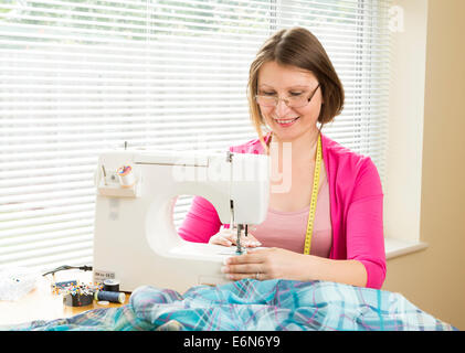 woman using a sewing machine Stock Photo