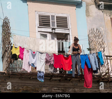 woman with laundry on balcony, Central Havana, Cuba Stock Photo