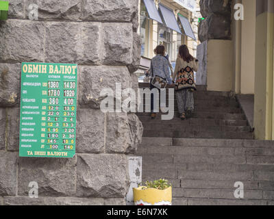 Bureau de Changes display their new exchange rates as the hryvnia weakens to a record 14.20 to dollar. 27th Aug, 2014. -- The Ukrainian Prime Minister Arseny Yatseniuk shouts out the danger of the falling Hryvnia if the conflict in the East lingers. Ukraine is waiting for a tranche of aid from the IMF which is deemed to help stabilise the currency. Credit:  Igor Golovniov/ZUMA Wire/Alamy Live News Stock Photo