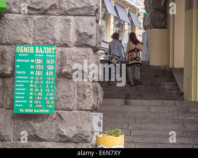 Bureau de Changes display their new exchange rates as the hryvnia weakens to a record 14.20 to dollar.  -- The Ukrainian Prime Minister Arseny Yatseniuk shouts out the danger of the falling Hryvnia if the conflict in the East lingers. Ukraine is waiting for a tranche of aid from the IMF which is deemed to help stabilise the currency. Credit:  Igor Golovnov/Alamy Live News Stock Photo