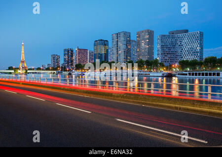 Colorful Eiffel Tower and Seine banks at sunset with light trails Stock Photo