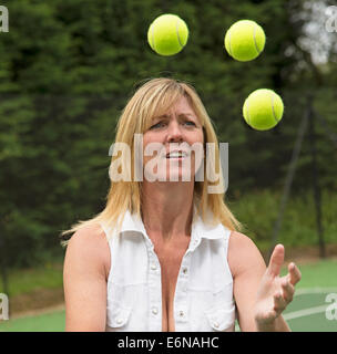 Tennis player juggling tennis balls Stock Photo