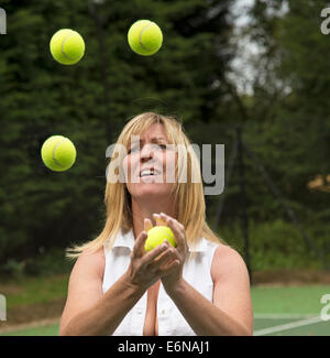 Tennis player juggling tennis balls Stock Photo