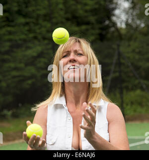 Tennis player juggling tennis balls Stock Photo