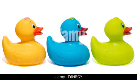 Three multi colored plastic bath toys in a row, isolated against a white background Stock Photo