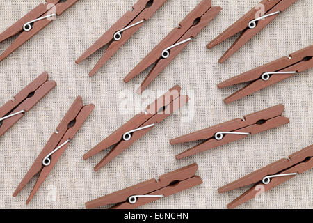 wooden clothespins on burlap background Stock Photo