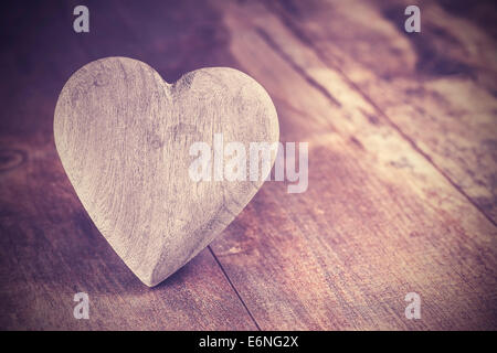 Vintage style heart on rustic wooden background, copy space. Stock Photo