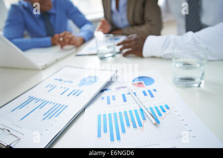 Clipboards, glass of water and pen at workplace in working environment Stock Photo