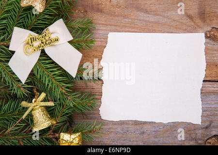 Blank Christmas card or invitation with gold envelope surrounded by decorations. Space for copy. Stock Photo