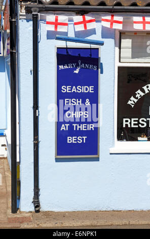 A sign outside a fish and chips shop at the east coast seaside resort of Cromer, Norfolk, England, United kingdom. Stock Photo