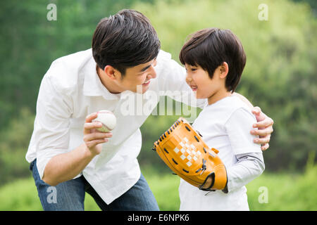 Father teaching son how to play baseball Stock Photo