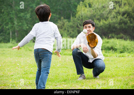 Father and son playing baseball Stock Photo