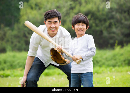 Father and son playing baseball Stock Photo