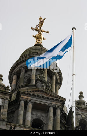 Scotland Flag flying on a pole with with wire supports above Glasgow City Chambers in Glasgow, Scotland, UK Stock Photo