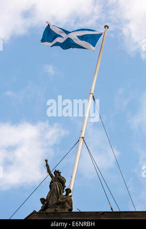 Scotland Flag flying on a pole with with wire supports above Glasgow City Chambers in Glasgow, Scotland, UK Stock Photo