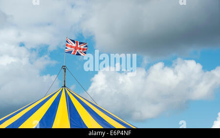 Union Jack Flag on a circus tent against a cloudy sky Stock Photo