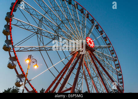 Nice Ferris wheel in late evening with beautiful lights in a park Stock Photo