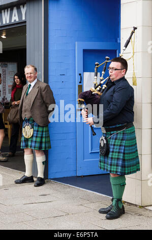 Male scottish bagpipe player wearing kilt outside Skipinnish Ceilidh House, Oban, Argyll & Bute, Scotland, UK. Skipinnish Ceilidh House is a Scottish traditional music venue in Oban.  Model Release: No.  Property Release: No. Stock Photo