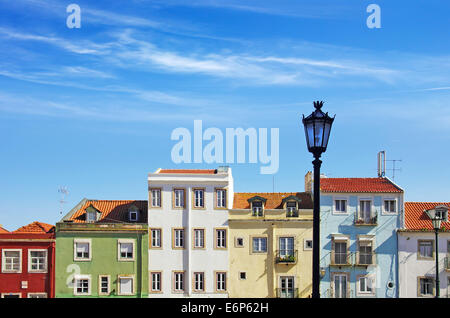 Picturesque Lisbon neighborhood with colorful block of houses under sunny blue sky Stock Photo