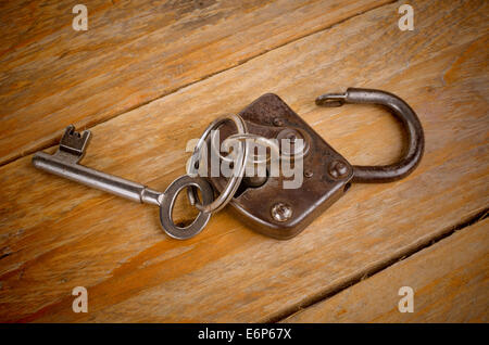 Vintage key inserted in an old padlock Stock Photo