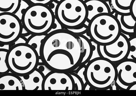 Emoticon faces concept. Black and white sad. In color is happy. The one ...