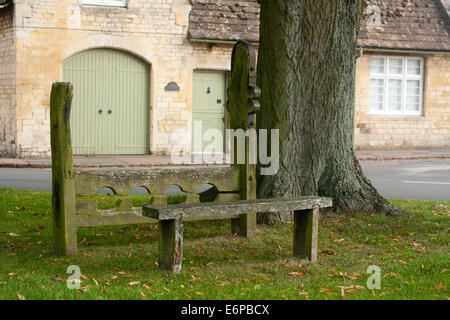 The stocks and whipping post on the village green at Market Overton near Oakham in Rutland, England, UK Stock Photo