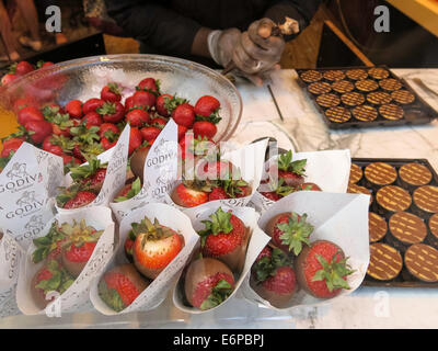 Godiva Chocolate Shop Window, Worker Readying Strawberries for Dipping, USA Stock Photo