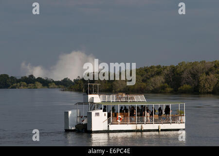 Cruise along the Victoria Falls aboard the ' African Queen'.  Other boats sailing in the Zambezi River. The sunset cruises vary Stock Photo