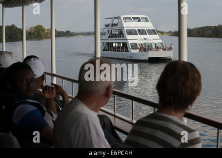 Cruise along the Victoria Falls aboard the ' African Queen'.  Other boats sailing in the Zambezi River. This is the “Lady Living Stock Photo