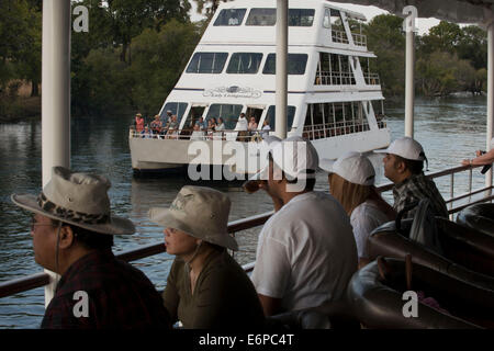 Cruise along the Victoria Falls aboard the ' African Queen'.  Other boats sailing in the Zambezi River. This is the “Lady Living Stock Photo