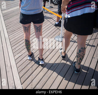 Tattooed visitors to Coney Island in Brooklyn in New York Stock Photo