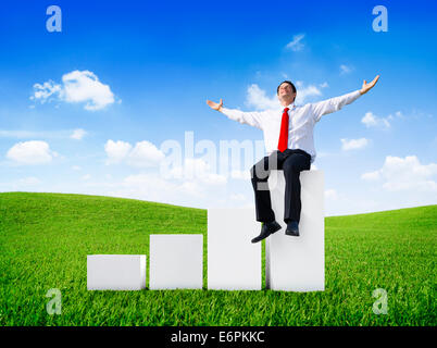 Successful Businessman Relaxing in an Open Field Stock Photo